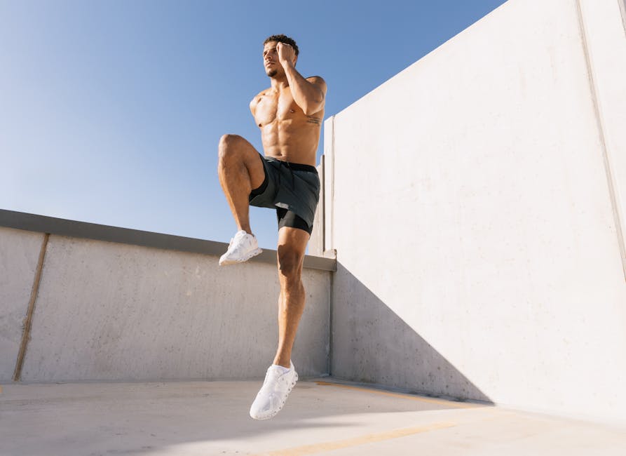 Male athlete doing cardio workout on a rooftop under blue sky in Austin, Texas.